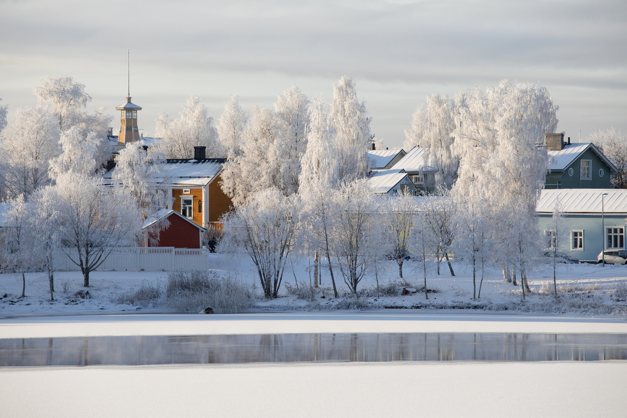 decorative; a view of Oulu in Winter showing a cyclist on a snowy bridge